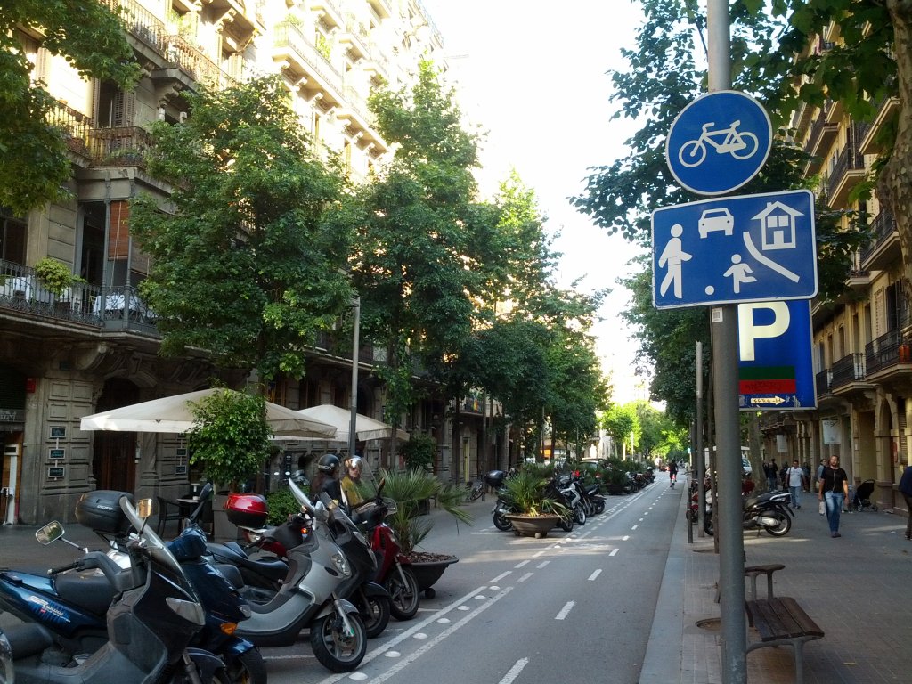 Woonerf street in Barcelona, Spain full of parked motorcycles
